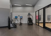 Thumbnail 70 of 126 - a gym with weights and cardio equipment in a building at SevenO2 Main Apartments, Salt Lake City, UT