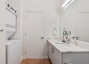 Thumbnail 78 of 126 - a white kitchen with a sink and a refrigerator at SevenO2 Main Apartments, Salt Lake City, Utah