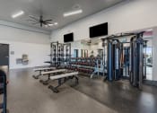 Thumbnail 71 of 126 - a gym with weights and cardio equipment in a building with white walls at SevenO2 Main Apartments, Utah, 84101