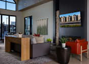 Thumbnail 14 of 52 - A modern living room with a fireplace and a large TV screen at Solhavn Apartments, American Fork, 84003
