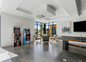 Thumbnail 46 of 136 - a living room with a pool table and a large window at The Flats at Riverwoods, Provo, Utah