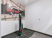 Thumbnail 72 of 136 - a green bike stand in the corner of a room at The Flats at Riverwoods, Provo, Utah