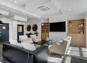Thumbnail 37 of 136 - a living room with a couch and chairs and a television at The Flats at Riverwoods, Provo, Utah