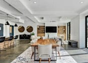 Thumbnail 53 of 136 - a dining room and living room with a wooden table and chairs at The Flats at Riverwoods, Provo, 84604