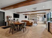 Thumbnail 39 of 136 - a living room and dining room with a table and chairs at The Flats at Riverwoods, Provo