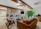 Thumbnail 41 of 136 - a living room with a couch and chairs and a fireplace at The Flats at Riverwoods, Provo, UT