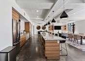 Thumbnail 49 of 136 - a large kitchen with a large island and a dining room at The Flats at Riverwoods, Provo, UT, 84604