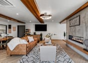 Thumbnail 60 of 136 - a living room with a couch and a fireplace at The Flats at Riverwoods, Provo, UT, 84604