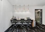 Thumbnail 24 of 136 - a conference room with a desk and chairs and a door at The Flats at Riverwoods, Provo, UT, 84604