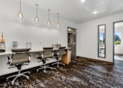 Thumbnail 26 of 136 - a conference room with a long desk and chairs and a window at The Flats at Riverwoods, Provo, Utah