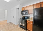 Thumbnail 26 of 50 - a kitchen with black appliances and wooden cabinetsat The View on 20th, Utah