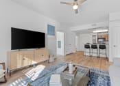 Thumbnail 28 of 50 - a living room with a tv and a kitchen in the backgroundat The View on 20th, Ogden, 84401
