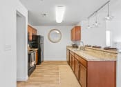 Thumbnail 25 of 50 - a spacious kitchen with granite counter tops and wooden cabinetsat The View on 20th, Ogden, UT, 84401