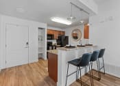 Thumbnail 22 of 50 - a kitchen with bar stools and a breakfast bar with three stoolsat The View on 20th, Ogden, UT