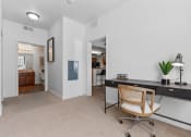 Thumbnail 33 of 50 - an office space with a desk and a chair and a doorway to a bathroomat The View on 20th, Ogden