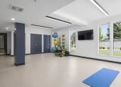 Thumbnail 75 of 136 - an empty room with a blue yoga mat and balloons at The Flats at Riverwoods, Provo, Utah