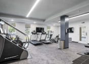 Thumbnail 84 of 136 - a gym with treadmills and other exercise equipment at The Flats at Riverwoods, Provo, UT