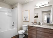 Thumbnail 131 of 136 - a bathroom with a white bathtub and a white toilet next to a sink with a mirror at The Flats at Riverwoods, Provo, UT, 84604
