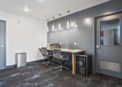 Thumbnail 51 of 136 - a small conference room with a desk and chairs at The Flats at Riverwoods, Provo, UT