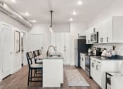 Thumbnail 65 of 84 - an open kitchen and dining area with a table and chairs at The Revival, Utah