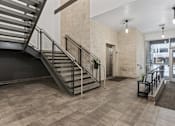 Thumbnail 31 of 71 - A staircase with a metal railing and a black handrail. at Wilmington Flats Apartments, Salt Lake City, 84106