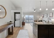 Thumbnail 12 of 71 - A modern kitchen with a large island and a view of the outdoors. at Wilmington Flats Apartments, Salt Lake City, UT