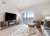 Thumbnail 14 of 71 - A modern living room with a flat screen TV and a fireplace at Wilmington Flats Apartments, Salt Lake City