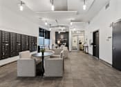 Thumbnail 29 of 71 - A black and white image of a modern office lobby with a table and chairs at Wilmington Flats Apartments, Utah, 84106
