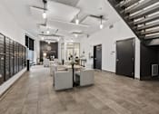 Thumbnail 3 of 71 - A spacious interior with a staircase on the right and a long wall of mailboxes on the left at Wilmington Flats Apartments, Salt Lake City, Utah