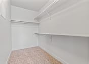 Thumbnail 26 of 71 - A white closet with a carpeted floor and a white shelf at Wilmington Flats Apartments, Salt Lake City