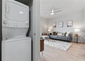 Thumbnail 17 of 71 - A white washing machine is in a laundry room at Wilmington Flats Apartments, Utah