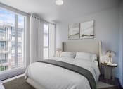 Thumbnail 9 of 22 - a bedroom with a bed and two windows
