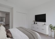 Thumbnail 8 of 22 - a bedroom with a large bed and a flat screen tv on the wall