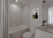 Thumbnail 12 of 22 - a small bathroom with a shower and toilet