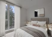 Thumbnail 7 of 22 - a bedroom with a large bed and a large window