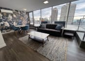 Thumbnail 8 of 19 - a living room with a view of the city and a couch and coffee table