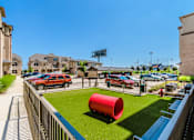 Thumbnail 10 of 27 - A red cylinder is in the middle of a grassy area at Atlas Point at Prestonwood Apartments , Texas, 75010