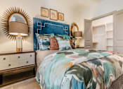 Thumbnail 27 of 27 - A bedroom with a bed, nightstands, and a mirror at Atlas Point at Prestonwood Apartments , Texas, 75010