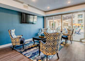 Thumbnail 7 of 27 - A living room with a blue wall and a television. at Atlas Point at Prestonwood Apartments , Texas, 75010