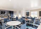 Thumbnail 13 of 29 - Business center with blue chairs and workstations at Chestnut Oaks Apartments, Maryland