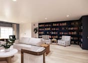 Thumbnail 15 of 29 - Modern living room with built in library wall at Chestnut Oaks Apartments, Fort Washington, Maryland