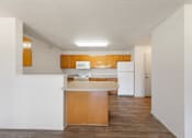 Thumbnail 14 of 28 - A kitchen with white appliances and wooden cabinets.