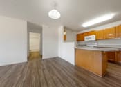 Thumbnail 17 of 28 - A kitchen with wooden cabinets and a white microwave.