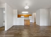 Thumbnail 27 of 28 - A kitchen with wooden floors and white walls.