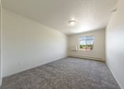 Thumbnail 21 of 28 - A room with a carpeted floor and a window.