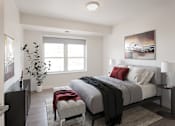 Thumbnail 2 of 15 - A bedroom with a large bed and a painting on the wall.