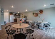 Thumbnail 9 of 21 - a dining room with tables and chairs and a kitchen