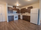 Thumbnail 21 of 21 - A kitchen with white appliances and brown cabinets.