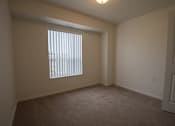 Thumbnail 15 of 21 - an empty room with a window and a door
