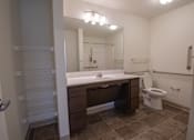 Thumbnail 13 of 21 - a bathroom with a large mirror and a sink and a toilet